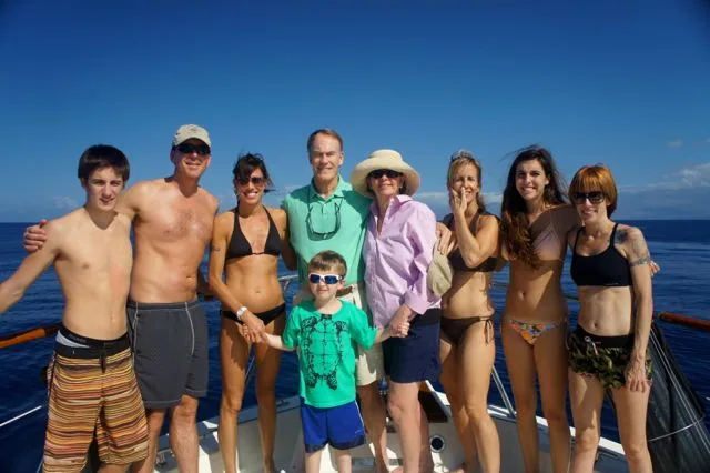 A group of people posing for a picture on a boat