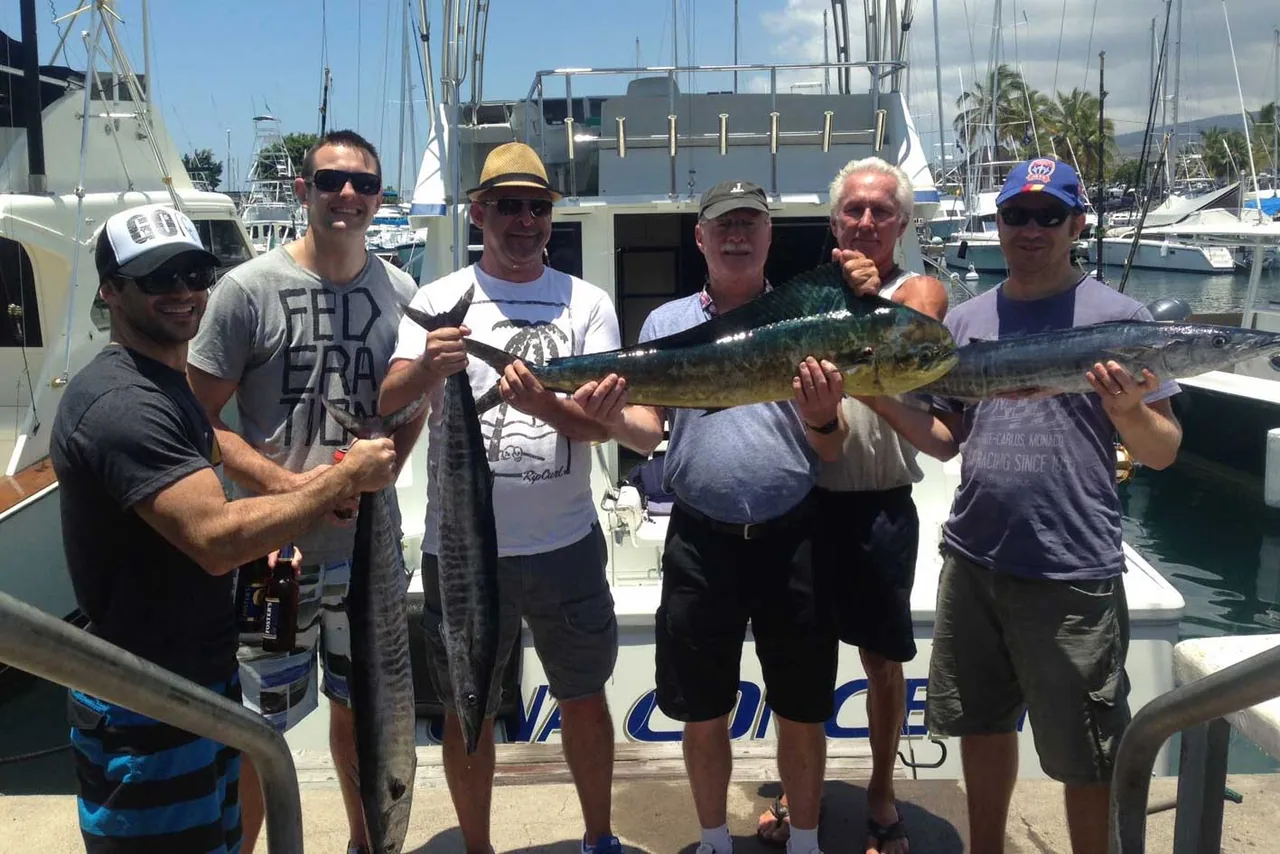 Miss Mojo: a group of men are standing on a boat holding fish